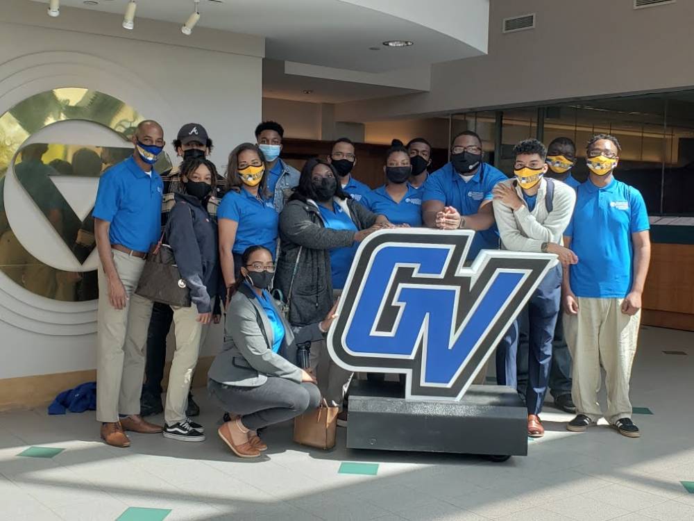 FVSU students and staff pose with the GV logo